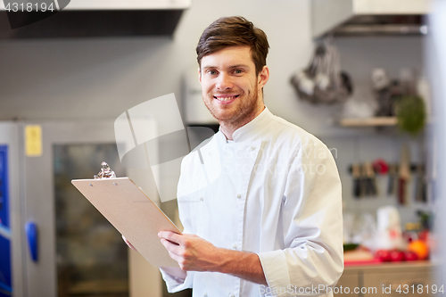 Image of chef with clipboard doing inventory at restaurant