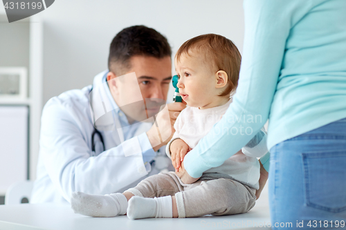 Image of doctor checking baby ear with otoscope at clinic