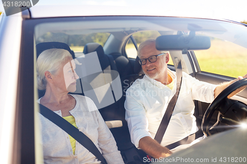 Image of happy senior couple driving in car