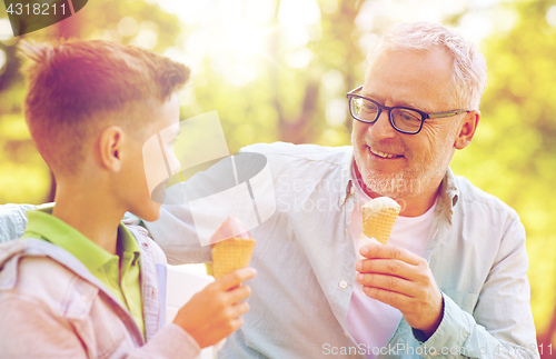 Image of old man and boy eating ice cream at summer park