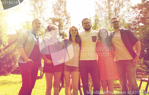 Image of happy teenage friends hugging at summer garden