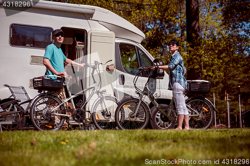 Image of Woman with a man on electric bike resting at the campsite.