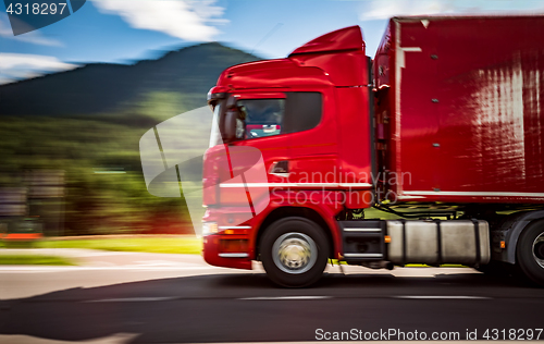 Image of Fuel truck rushes down the highway in the background the Alps. T