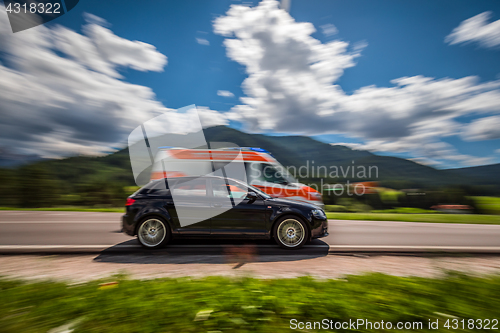 Image of Car at high speed gives way to ambulance road