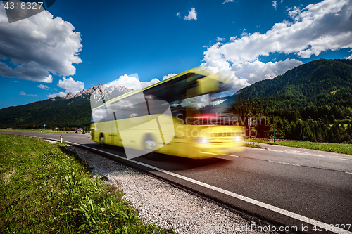 Image of Yellow Public bus traveling on the road
