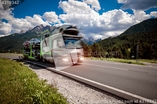 Image of Truck trailer transports new cars rides on highway