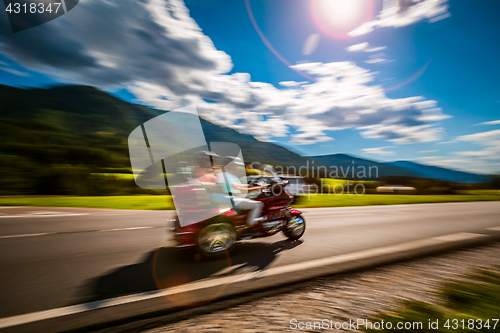 Image of Tricycle Blurred motion Bikers on the road