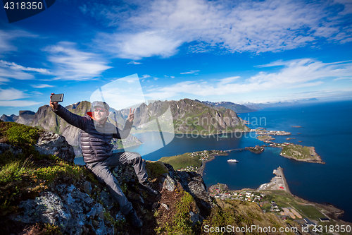 Image of Man on top of a mountain taking a selfie