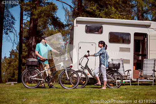 Image of Woman with a man on electric bike resting at the campsite.