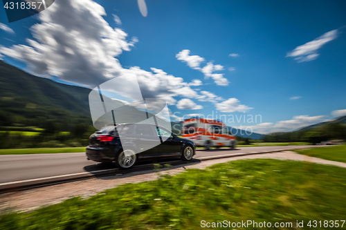 Image of Car at high speed gives way to ambulance road