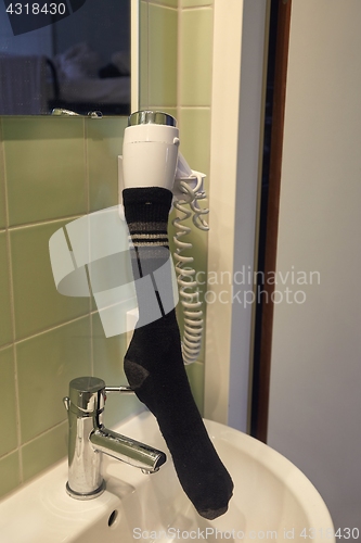 Image of Drying sock in a hairdryer