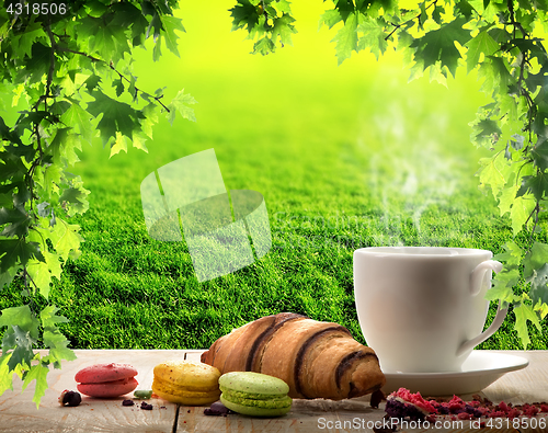 Image of White cup and macaroons