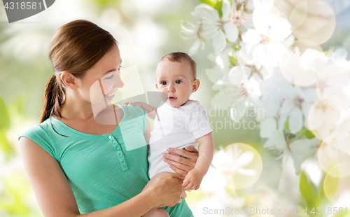 Image of happy young mother with baby over cherry blossoms