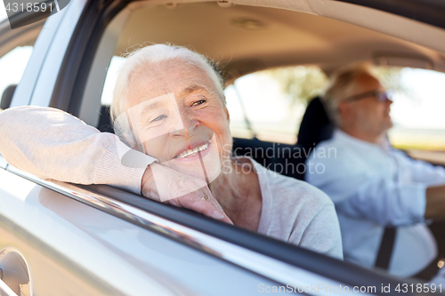 Image of happy senior couple driving in car