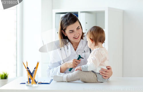 Image of doctor with baby and otoscope at clinic