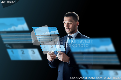 Image of businessman with tablet pc and exchange charts