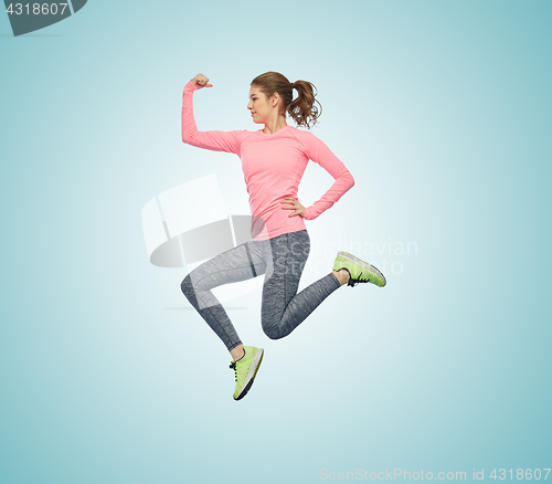 Image of happy smiling sporty young woman jumping in air