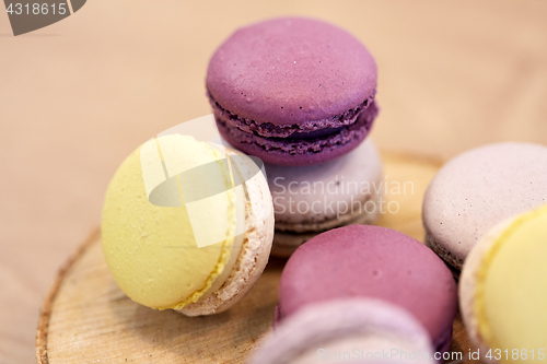 Image of close up of different macarons on wooden stand