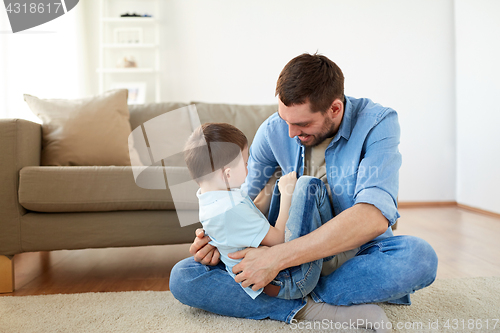 Image of father with son playing and having fun at home