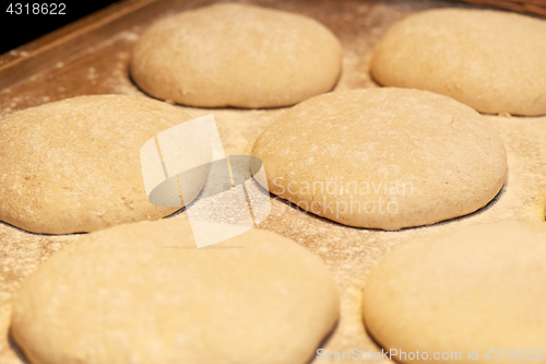 Image of yeast bread dough on bakery kitchen table