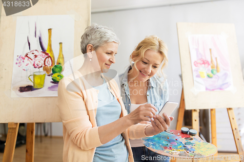 Image of artists with smartphone painting at art school