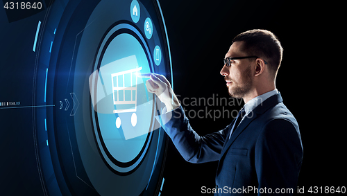 Image of businessman with shopping cart on virtual screen