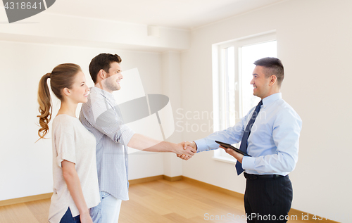 Image of man and realtor shaking hands at new home