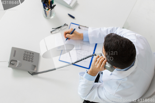 Image of doctor with prescription calling on phone