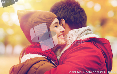 Image of happy young couple hugging in autumn park