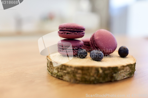 Image of blueberry macarons on wooden stand