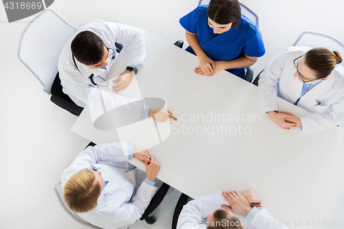 Image of doctor showing something imaginary on table