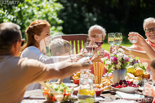 Image of happy family having dinner or summer garden party