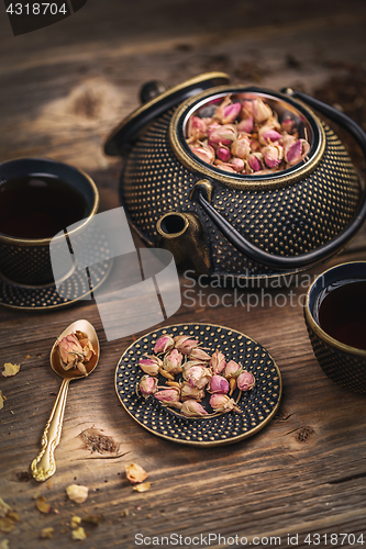 Image of Cup of hot tea and iron teapot