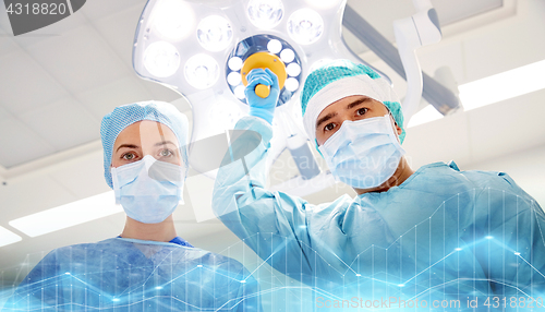 Image of group of surgeons in operating room at hospital