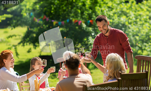 Image of happy family having dinner or summer garden party