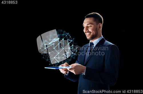 Image of businessman with tablet pc and low poly projection