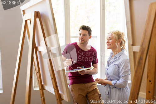 Image of artists with palette and easel at art school