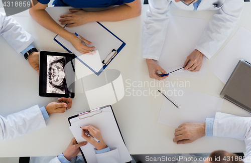 Image of doctors with jaw x-ray on tablet pc at clinic