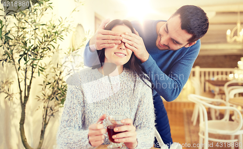 Image of happy couple drinking tea at cafe