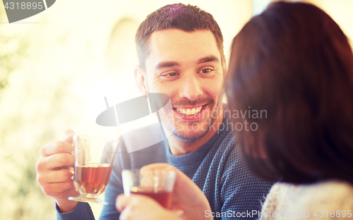 Image of happy couple drinking tea at cafe