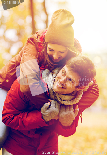 Image of happy young couple having fun in autumn park