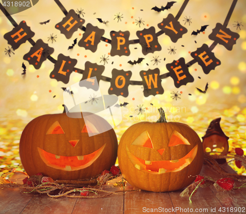 Image of carved pumpkins and happy halloween garland