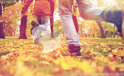 Image of young couple running in autumn park