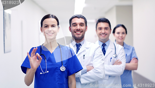 Image of group of happy medics or doctors at hospital