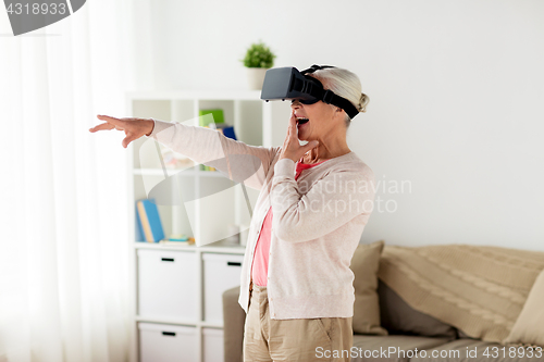 Image of old woman in virtual reality headset or 3d glasses