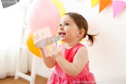 Image of happy baby girl on birthday party at home