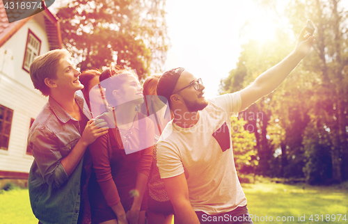 Image of friends taking selfie at party in summer garden