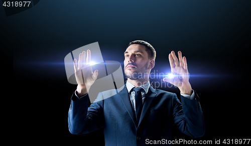 Image of businessman with laser light over black