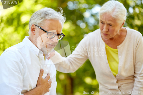 Image of senior man feeling sick at summer park