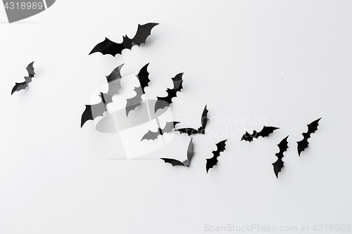 Image of black paper bats over white background